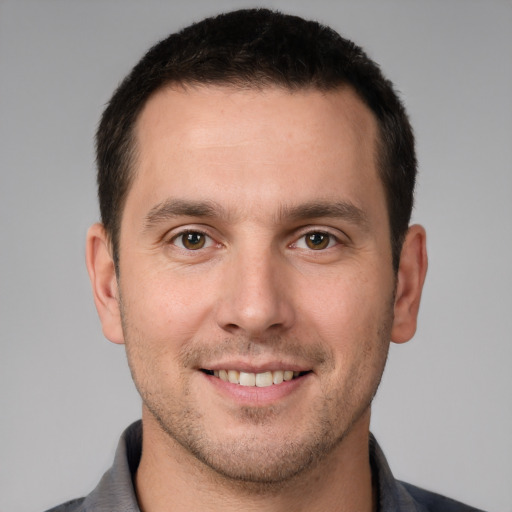 Joyful white young-adult male with short  brown hair and brown eyes