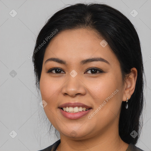 Joyful latino young-adult female with long  black hair and brown eyes