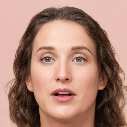 Joyful white young-adult female with medium  brown hair and green eyes