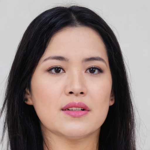 Joyful asian young-adult female with long  brown hair and brown eyes