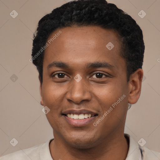Joyful black young-adult male with short  black hair and brown eyes