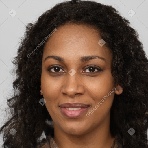 Joyful black young-adult female with long  brown hair and brown eyes