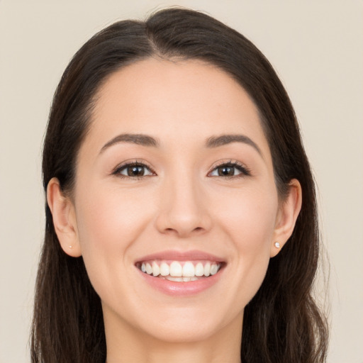 Joyful white young-adult female with long  brown hair and brown eyes