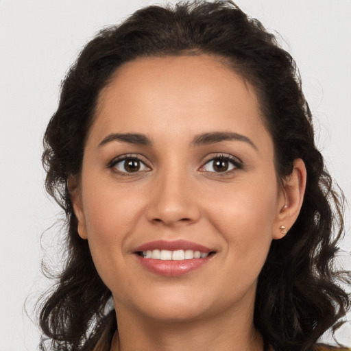 Joyful white young-adult female with long  brown hair and brown eyes