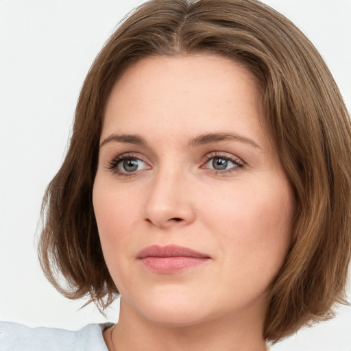 Joyful white young-adult female with medium  brown hair and green eyes