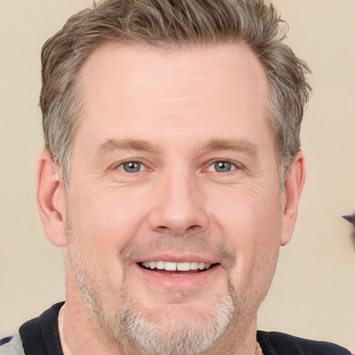 Joyful white adult male with short  brown hair and grey eyes