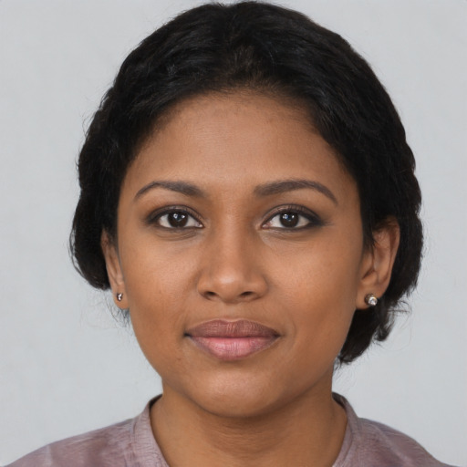 Joyful black young-adult female with medium  black hair and brown eyes