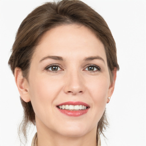 Joyful white young-adult female with medium  brown hair and grey eyes