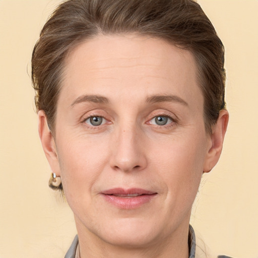 Joyful white adult female with short  brown hair and grey eyes