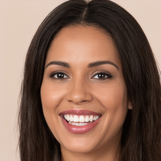 Joyful white young-adult female with long  brown hair and brown eyes