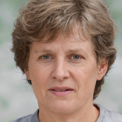 Joyful white middle-aged female with medium  brown hair and grey eyes