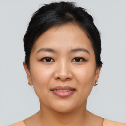 Joyful asian young-adult female with short  brown hair and brown eyes