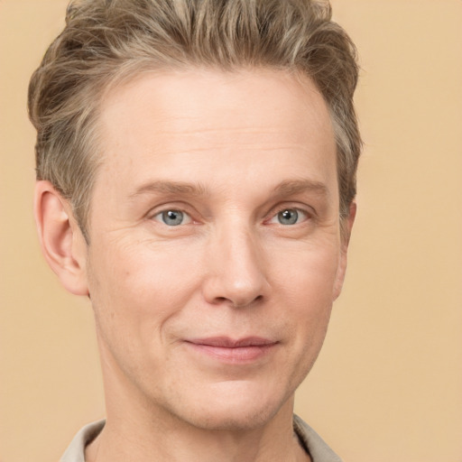 Joyful white adult male with short  brown hair and grey eyes