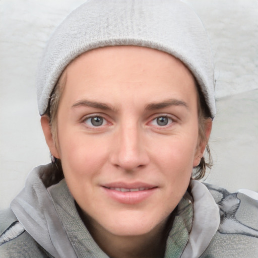 Joyful white young-adult female with short  brown hair and blue eyes