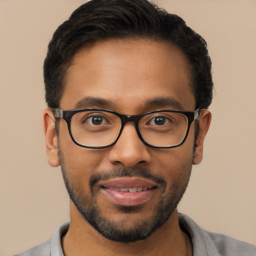 Joyful latino young-adult male with short  brown hair and brown eyes