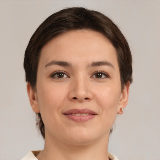 Joyful white young-adult female with medium  brown hair and brown eyes