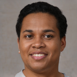 Joyful black young-adult male with short  brown hair and brown eyes