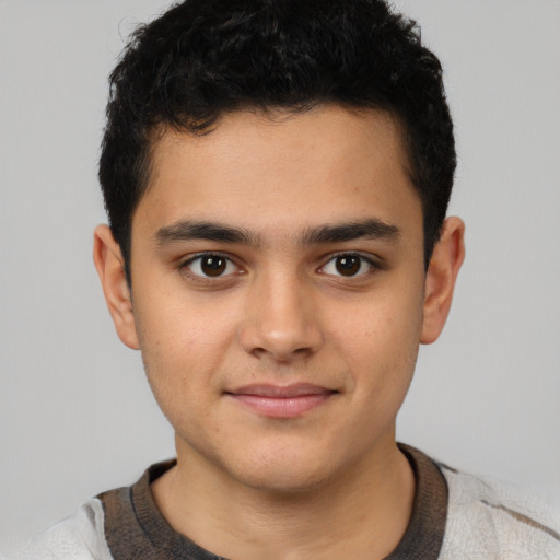 Joyful latino child male with short  brown hair and brown eyes