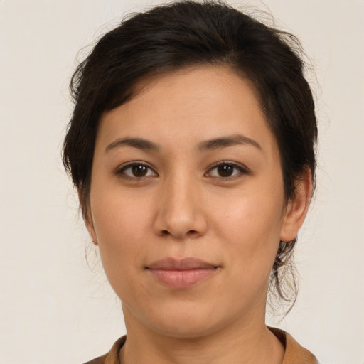 Joyful latino young-adult female with medium  brown hair and brown eyes
