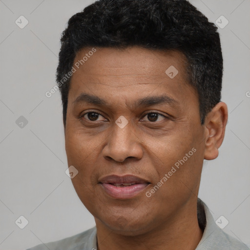 Joyful black adult male with short  black hair and brown eyes