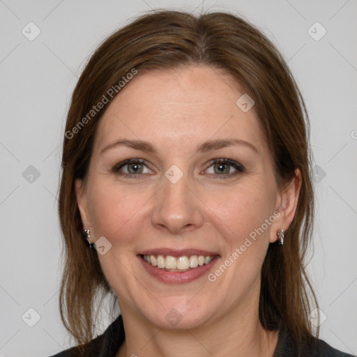 Joyful white adult female with medium  brown hair and grey eyes