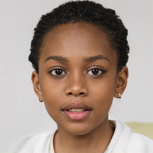 Joyful black child female with short  brown hair and brown eyes