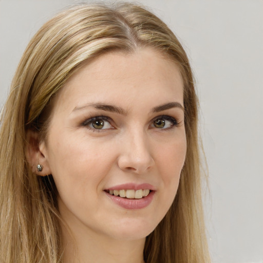 Joyful white young-adult female with long  brown hair and green eyes