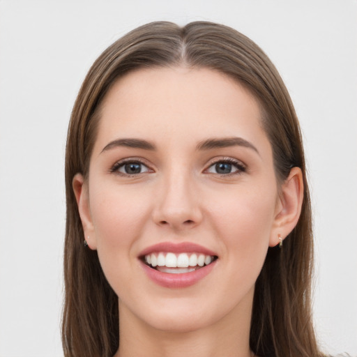 Joyful white young-adult female with long  brown hair and grey eyes