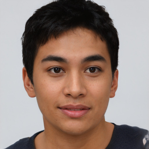 Joyful asian young-adult male with short  black hair and brown eyes