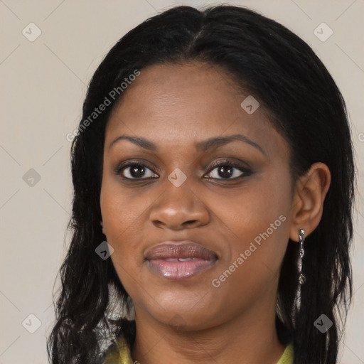 Joyful black young-adult female with long  black hair and brown eyes