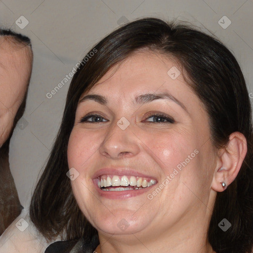 Joyful white adult female with medium  brown hair and brown eyes