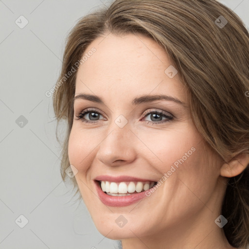 Joyful white young-adult female with long  brown hair and green eyes