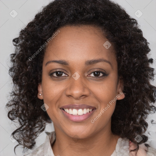 Joyful black young-adult female with long  brown hair and brown eyes