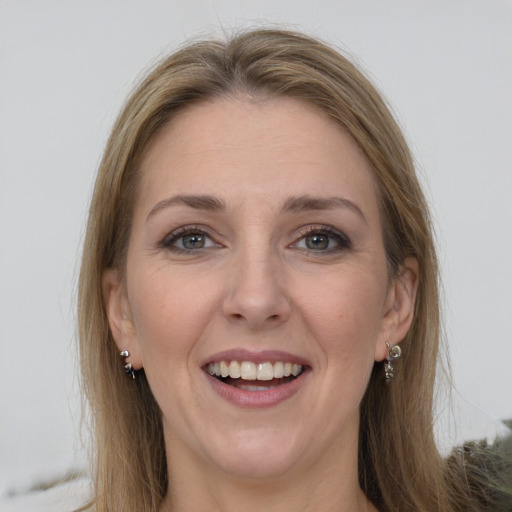 Joyful white young-adult female with long  brown hair and grey eyes