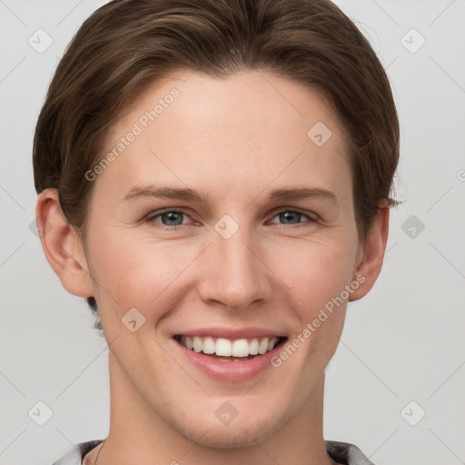 Joyful white young-adult female with short  brown hair and grey eyes