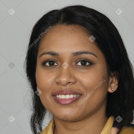 Joyful black young-adult female with long  black hair and brown eyes