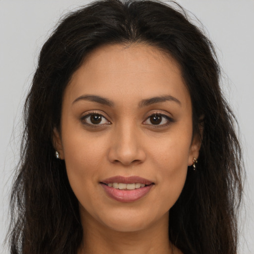 Joyful latino young-adult female with long  brown hair and brown eyes