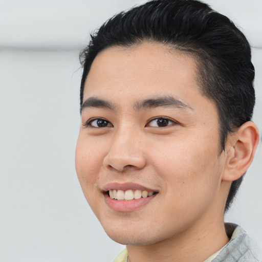 Joyful asian young-adult male with short  black hair and brown eyes