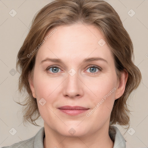 Joyful white adult female with medium  brown hair and blue eyes