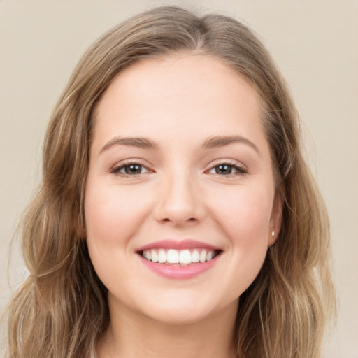 Joyful white young-adult female with long  brown hair and grey eyes