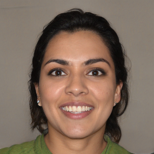 Joyful latino young-adult female with medium  black hair and brown eyes