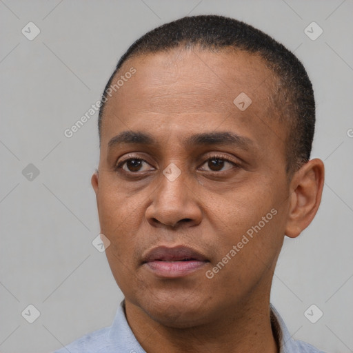 Joyful latino adult male with short  black hair and brown eyes