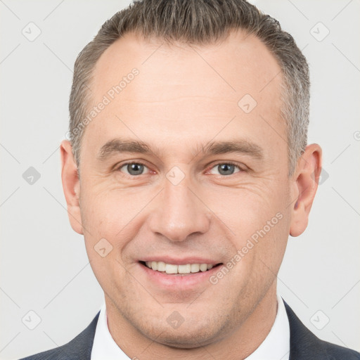 Joyful white adult male with short  brown hair and brown eyes