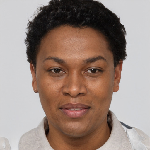 Joyful black adult female with short  black hair and brown eyes