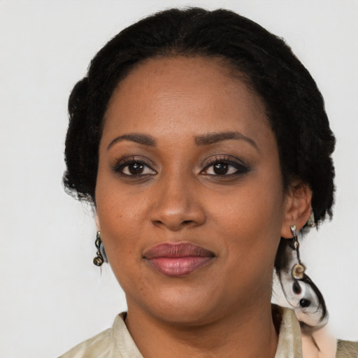 Joyful black adult female with medium  black hair and brown eyes