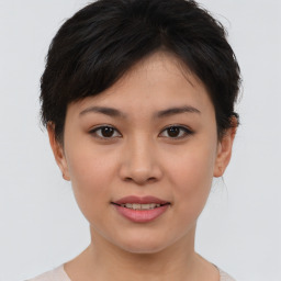 Joyful asian young-adult female with short  brown hair and brown eyes