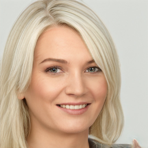 Joyful white young-adult female with long  blond hair and blue eyes