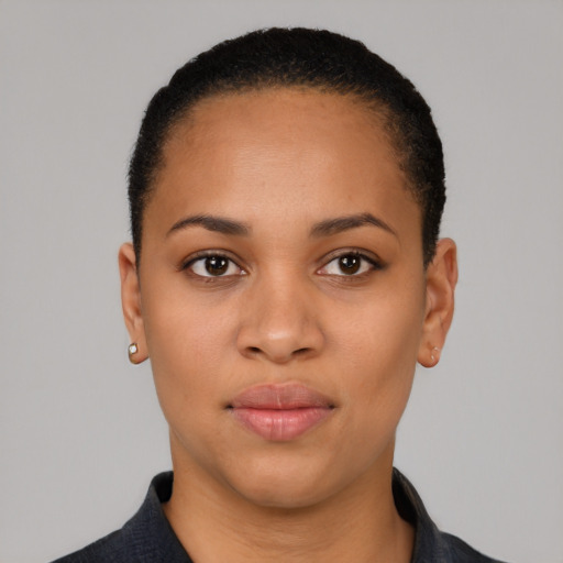 Joyful latino young-adult female with short  black hair and brown eyes