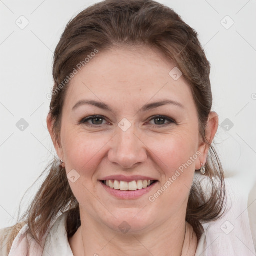 Joyful white young-adult female with medium  brown hair and grey eyes