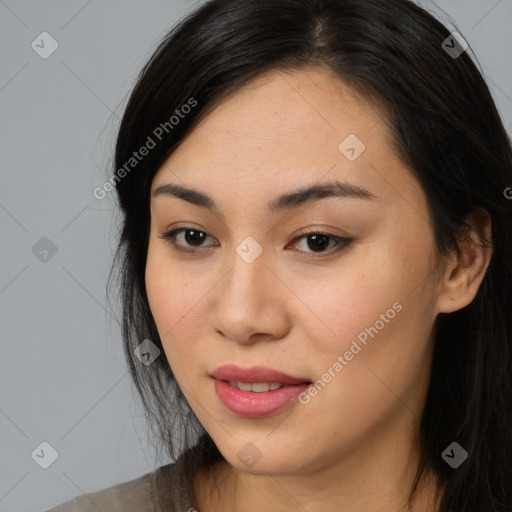 Joyful asian young-adult female with long  brown hair and brown eyes